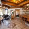 Cozy hotel bar with wooden furniture and decorative tiled floor.