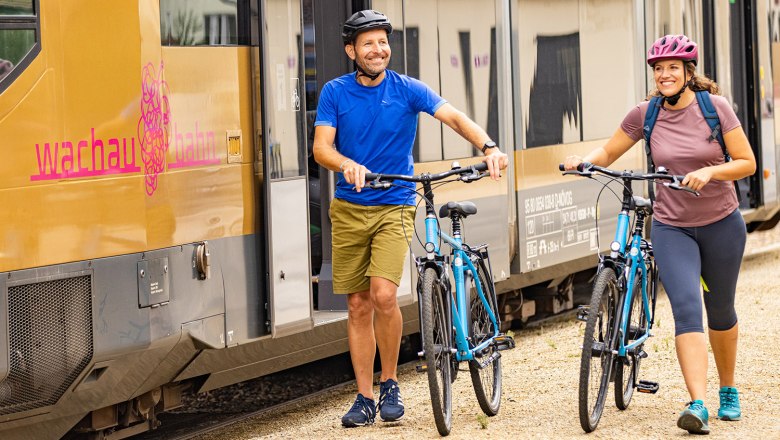 Radfahrer und Radfahrerin neben der Wachaubahn